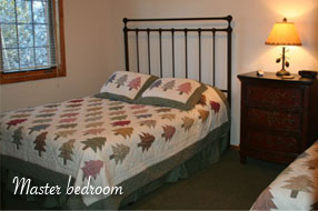 Image of the Master bedroom in the Executive Home at Angler's Isle Northwoods Resort.